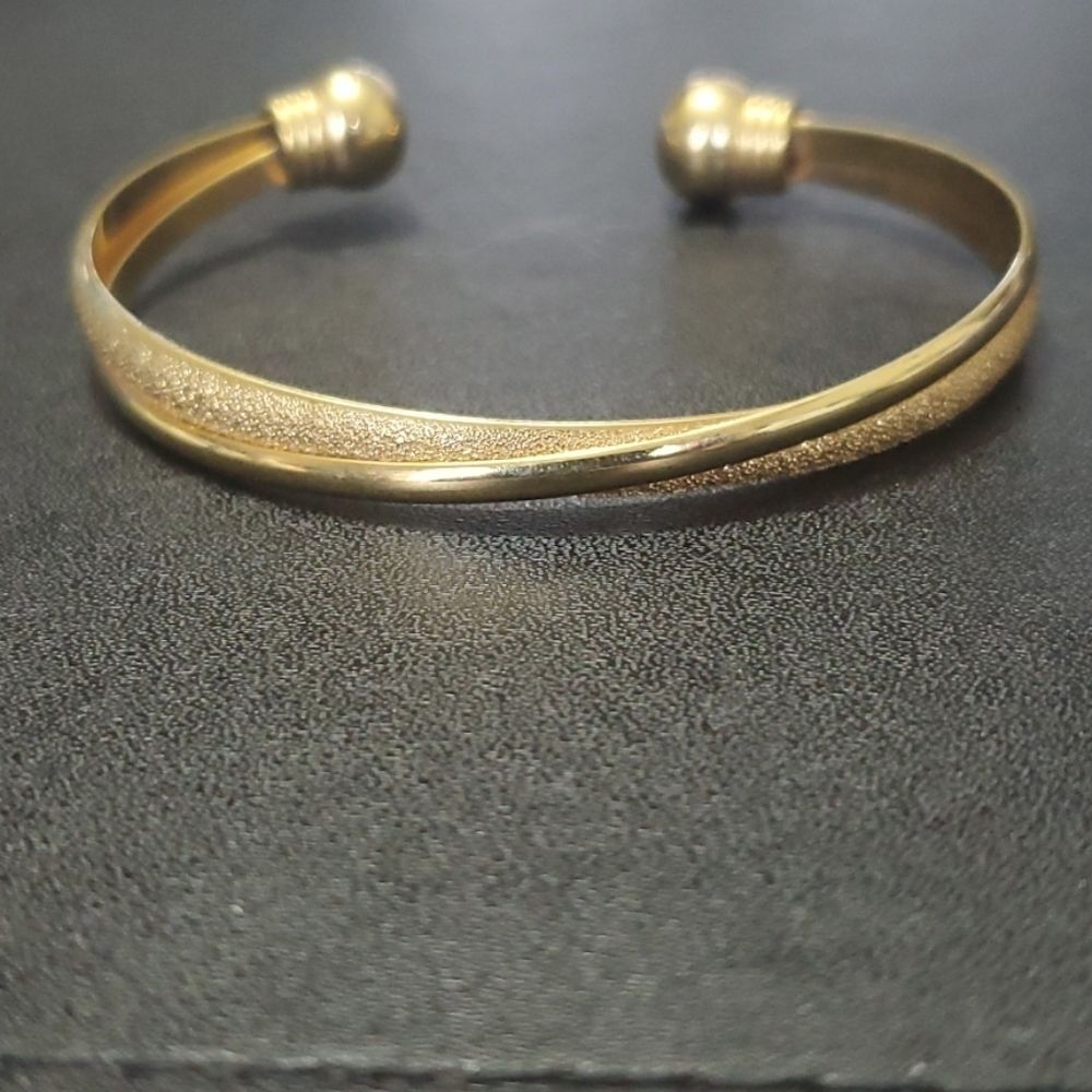Gold tone cuff bracelet 6.75"